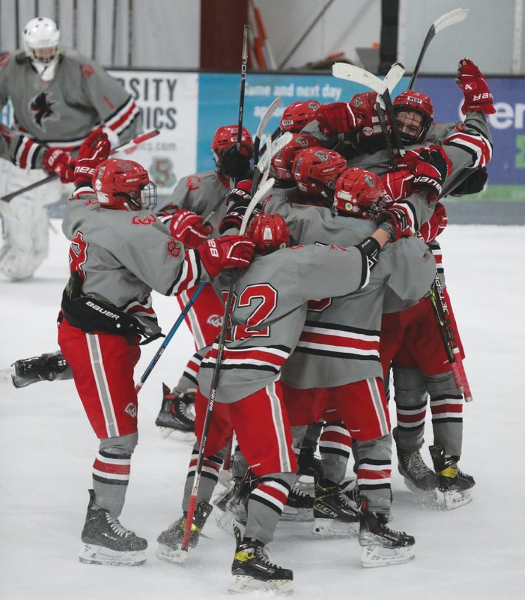 ON TO THE NEXT ROUND: The Cranston co-op boys hockey team celebrates after scoring the game-winning shot on Monday night in the Division II preliminary round. (Photos by Mike Zawistoski)