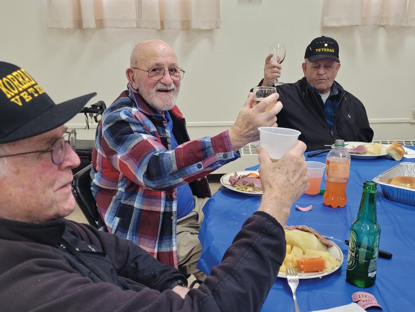 CHEERS: Ernie Cafolla, 97, at right, lifts his glass to toast his table-mates &mdash; Joe Mullen, 90, a Seekonk native and ex-Army first lieutenant; Donald LaBelle, 91, formerly of Charlestown, a former Air Force airman first class &mdash; who all lifted their bottles and goblets. (Sun Rise photos by Rory Schuler)