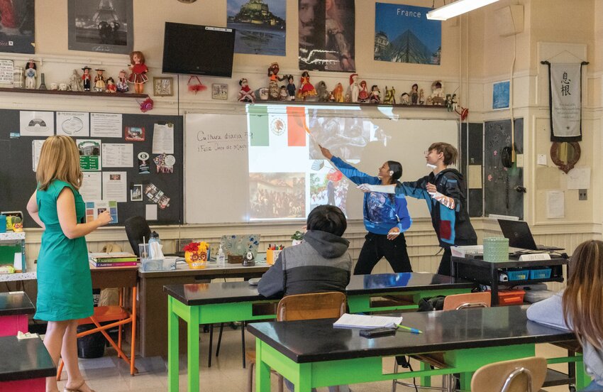 BRINGING THE WORLD TO CRANSTON SCHOOLS: World Language Teacher Rebecca Hobin looks on as students demonstrate their passion for learning more about the world through language. (Photo by Stephanie Bernaba)