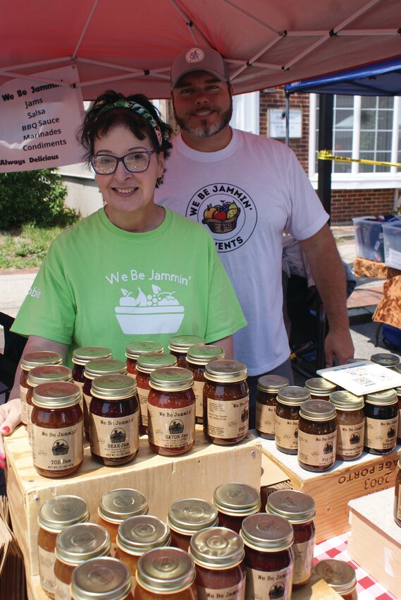 JOIN US THIS WEEKEND: Debbie Wood of We Be Jammin&rsquo; and Bryan LeBeau show off the jams and jellies available while taking in the amazing work Wood did in organizing the massive list of vendors at the 2023 Spring Festival earlier this year.