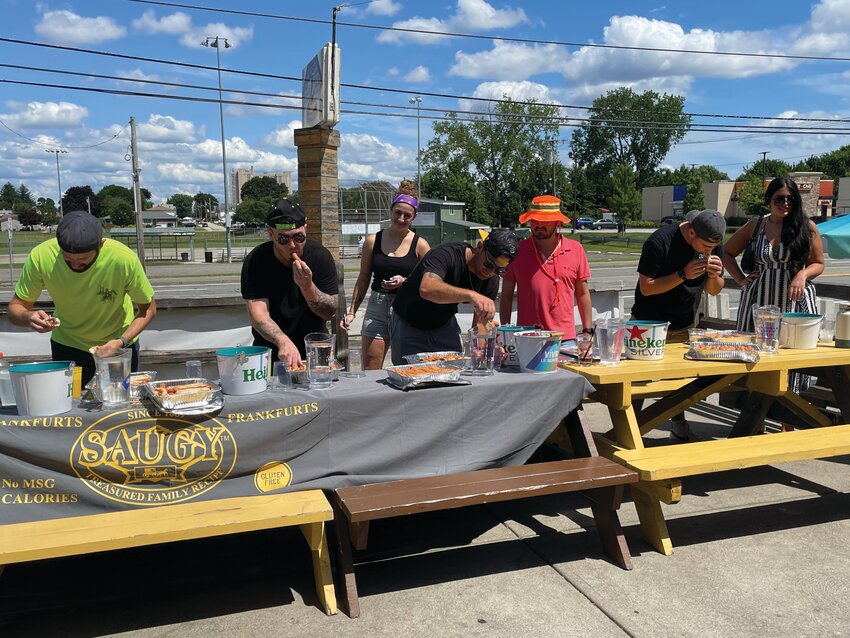 WHO THOUGHT THIS WAS A GOOD IDEA: Contestants at the Thirsty Beaver inaugural hot dog eating contest get their grooves on. (Photo by Pam Schiff)