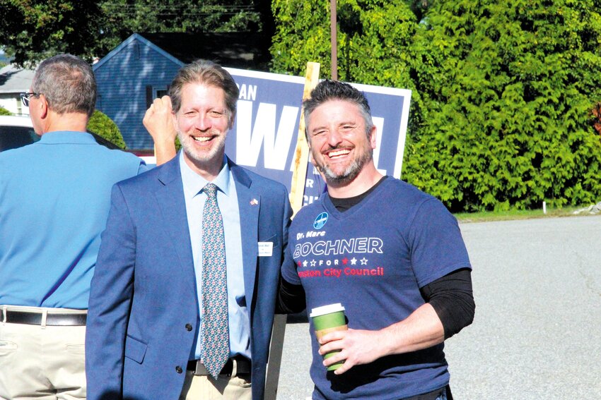 CHUMMY COMPETITORS: Independent Marc Bochner, right, wore his campaign shirt to the polls Tuesday. He and Democratic candidate Daniel Wall hung out as voters trickled in to cast their ballots Tuesday morning.