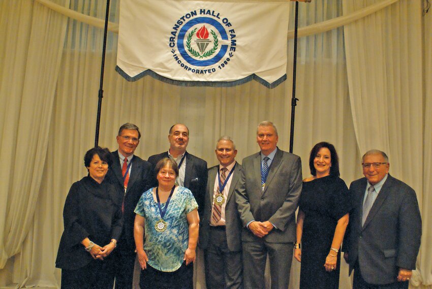 WELCOME TO THE HALL: President of the Cranston Hall of Fame Society Cindy Soccio (far left) stands with the five inductees and Cranston School Department Superintendent Jeannine Nota-Masse (second from right) and School Committee chair and former Mayor Michael Traficante (right). (Photo by Steve Popiel)