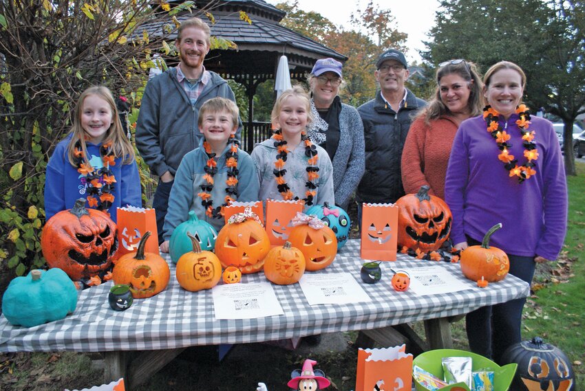 A LITTLE TASTE: As the night gets closer and jack-o-lanterns start showing up they start piling up on the table before being spread out on the lawn for people to view. Pictured are (front left to right) 11-year-old Hanna McNally, 7-year-old Oliver Shannon, his sister 9-year-old Ruth Shannon, (back left to right) Member of Oaklawn Grange Executive Committee Mike McNally, Chaplain Jean Lamb, Committee Member Ray Klein, Grange Secretary Maria Manzi and Coordinator of the Event Rachael McNally.