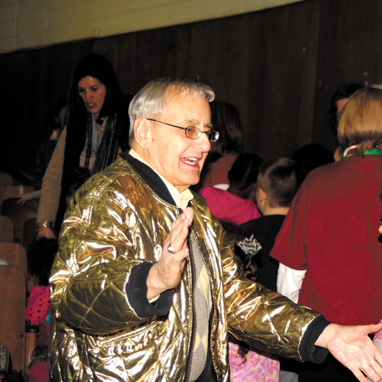 A HIT WITH KIDS: Clad in his gold jacket, Alan Shawn Feinstein addresses Aldrich Junior High students in this photo from 2014. (Warwick Beacon photo)