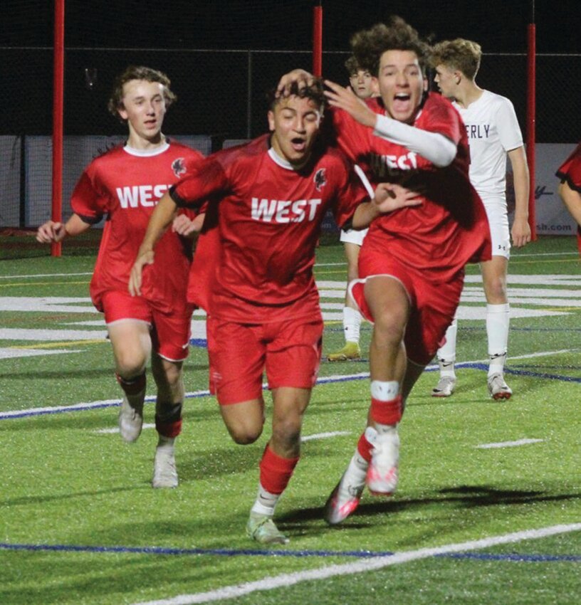BIG WIN: Members of the West boys soccer team celebrate after a goal. (Photos by Alex Sponseller)