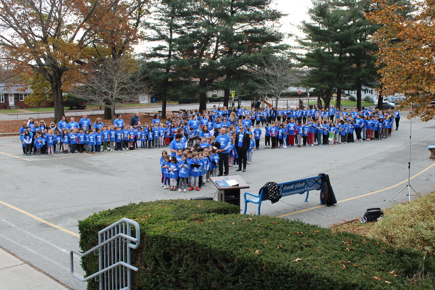 A blue ribbon of students   at Woodridge School. Photos provided by CPSED