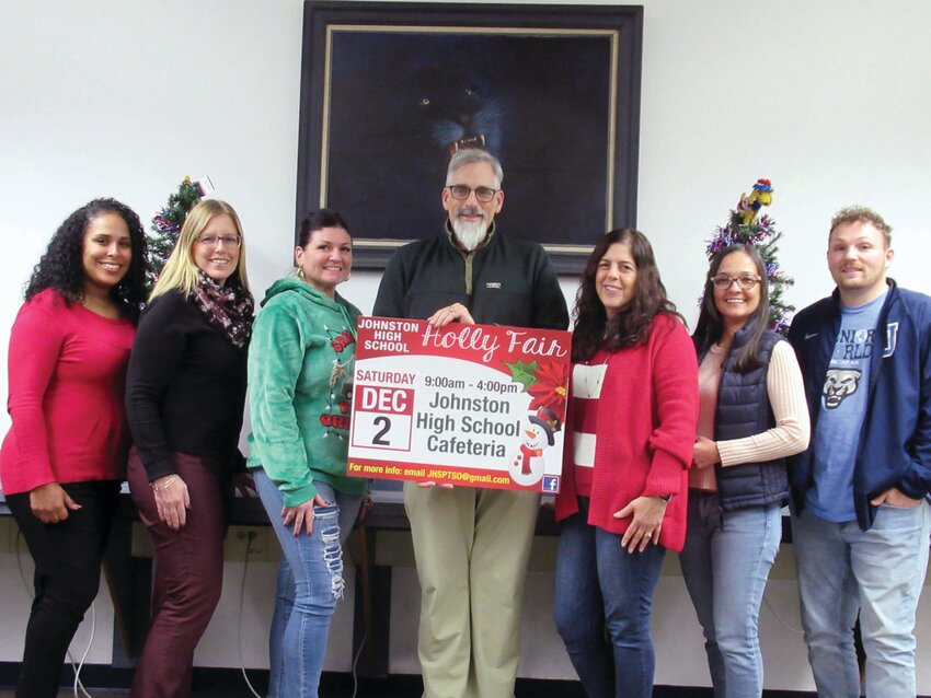 FAIR FOLKS: Lance Niles (center), president of the Johnston PTSO, holds a special sign made by Bori Graphics for this Saturday&rsquo;s Holily Fair. He&rsquo;s joined by committee member Lina Cruz, Rachel Salvatore, Tiffany DiBiasio, Angela Niles, Susana Cuellar-Daza and Mike Harwood.