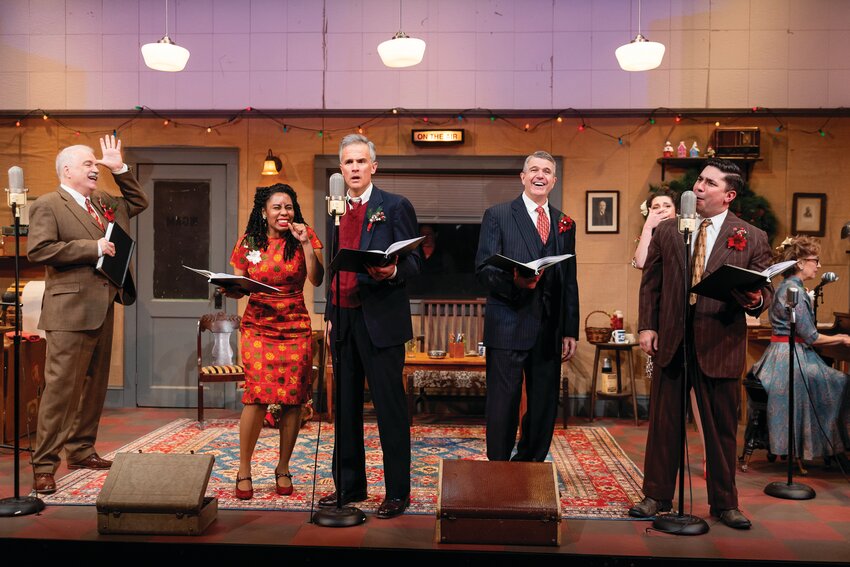 Fred Sullivan, Jr. (Henry F. Potter/ Clarence), Lynsey Ford (Mary Hatch), Tony Estrella (George Bailey), Jim O'Brien (Joseph/Billy Bailey),  Andrew Iacovelli (Harry Bailey, Ernie Bishop) Background L to R: Helena Tafuri (Violet Bick, Janie Bailey/Others), Milly Massey (Announcer/Zuzu Bailey)