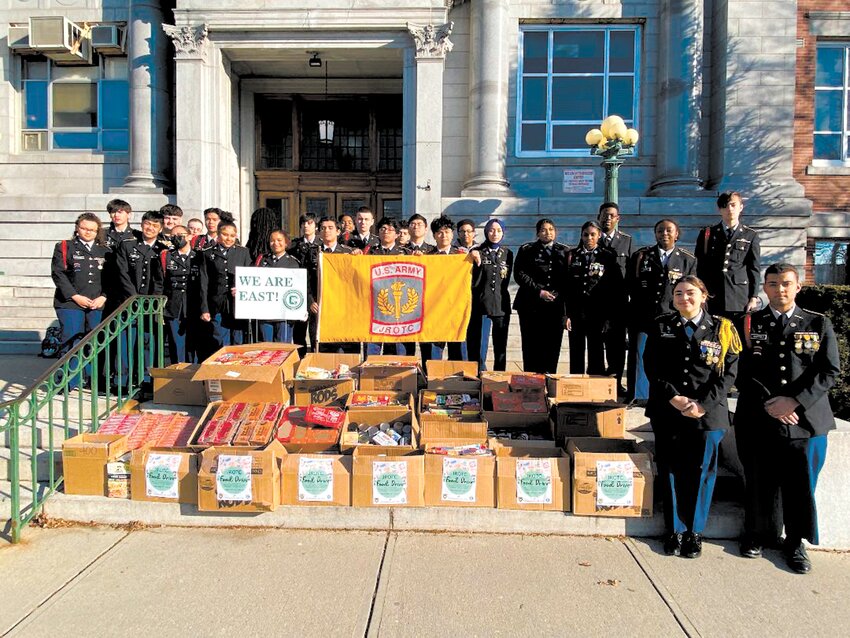 TEAM WORK MAKES THE DREAM WORK: Members of the Cranston JROTC pose with their food collection to be passed along to CCAP. (Photos courtesy of Cranston East JROTC)