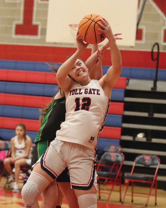 LOOKING TO REBOUND: Toll Gate&rsquo;s Adeline Areson hauls in a rebound on Monday night. (Photos by Mike Zawistoski)