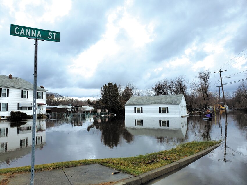 WATCH WHERE YOU DRIVE: Several streets off of River St. in West Warwick near Natick Bridge were underwater Wednesday morning, including Canna St. (Photo by Kevin Fitzpatrick)