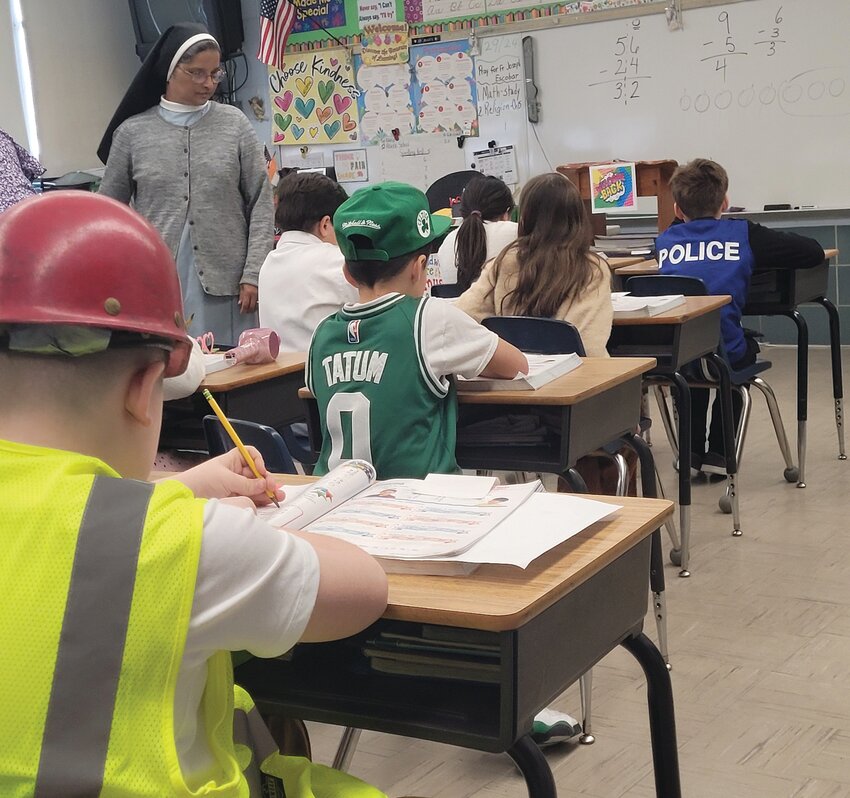 WHEN THEY GROW UP: Students in Sister Daisy Kollamparampil&rsquo;s second-grade class were dressed as their possible future vocations during Career Day on Monday. Sr. Daisy returned to the job on Jan. 10, more than two months after she was seriously injured in the crosswalk outside the school.