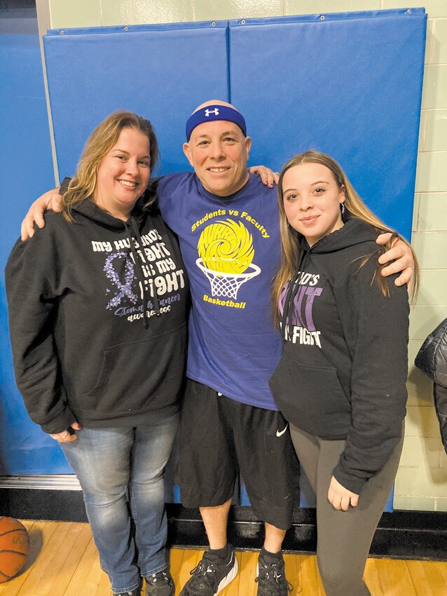 FIGHTING AS A FAMILY: Jay Almeida and his family- wife Nicole Almeida and daughter Talia Almeida- pose together at the game. Their sweatshirts read &ldquo;My husband&rsquo;s fight is my fight&rdquo; and &ldquo;My dad&rsquo;s fight is my fight,&rdquo; respectively.