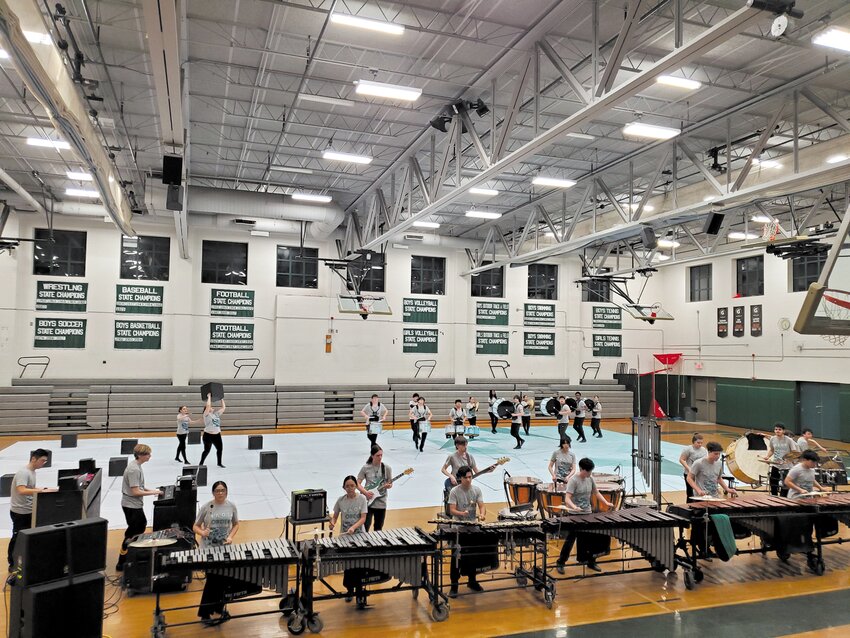 CIRCLE UP: The members of the Cranston Combined Percussion Ensemble sit and listen to the advice of a WGI judge following their full performance on Saturday night. (Photos by Kevin Fitzpatrick)