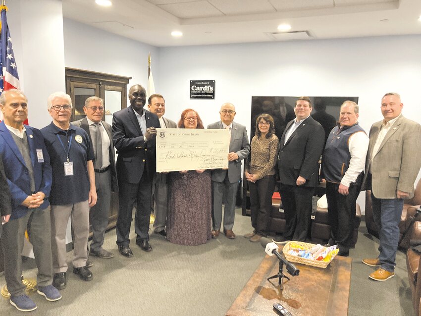 FULL HOUSE: Members of the Rhode Island House of Representatives and Rhode Island Military Organization (RIMO) pose with a ceremonial check for $20,000.