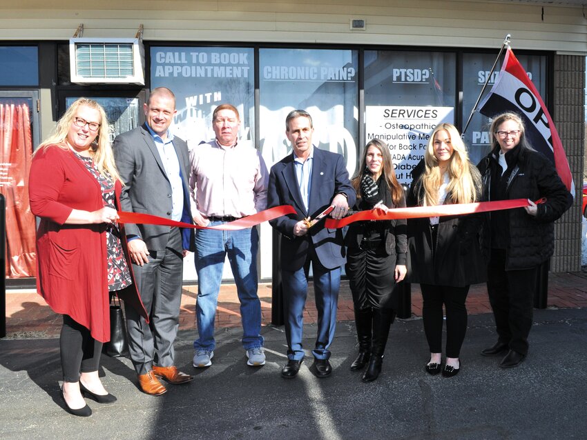 THE CEREMONY COMMENCES: Mayor Frank Picozzi prepares to cut the ribbon in front of Everyday Medicinals’ Warwick Ave. office (L-R) Central Rhode Island Chamber of Commerce (CRICoC) Director of Membership and Marketing Jennifer Wheelehon, CRICoC Chairman of the Board Michael Aurecchia, family friend Rich Chase, Picozzi, founder Amanda Cheatom, Cetrified Health Coach Amanda Prado and CRICoC CEO Lauren Slocum. (Photo courtesy of Lev Poplow)