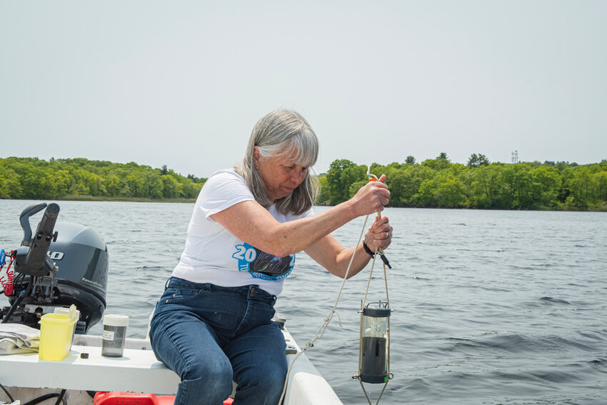 DEDICATED VOLUNTEER: Veronica Berounsky, Ph.D. 90, takes a sample from Narrow River. The alumni relations and communications coordinator for URI&rsquo;s Graduate School of Oceanography&rsquo;s Public Engagement office, has been a Watershed Watch volunteer for more than two decades. (URI photo by Nora Lewis}