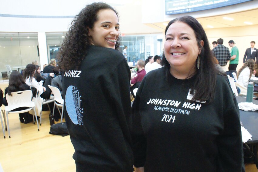 TEAM DESIGNER: Janelle Nunez and Coach Kerry Murphy pose for a photo in the official Johnston High Academic Decathlon sweatshirt, which Nunez designed.