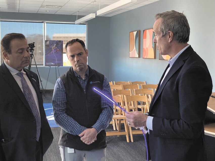 DISCUSSING THE DETAILS: IlluminOss chairman Mike Mogul (right) discusses the benefits of his company&rsquo;s product with Speaker of the House Joe Shekarchi and Ortho RI CEO Michael Bradley.