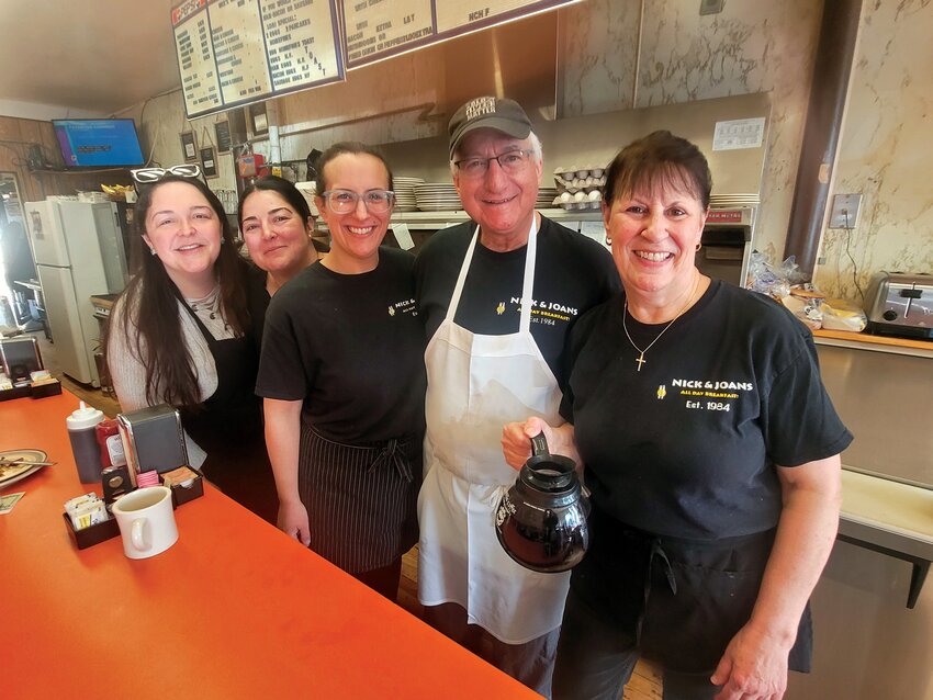 CELEBRATION TIME: Nick and Joan DeGaitas (second from right and far right) celebrated their business&rsquo;s 40th anniversary with family, friends and staff, including (L-R) servers Allie Alfonso-El-Sayed, Antonia Anthony and daughter Michaela Boadih.