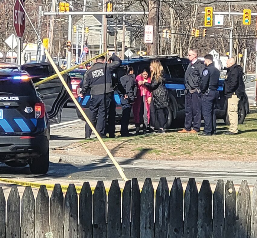 LOOKING FOR EVIDENCE: Warwick patrol officers paced the parking lot of Electronic Alarm Systems, Inc., scanning the macadam for possible evidence. They walked with their heads bowed, eyes focused on the ground.