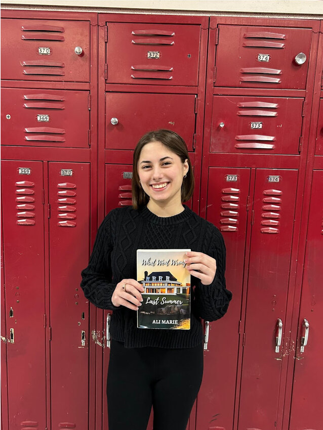 Sophomore Alessandra Russo holding her most recent novel, What Went Wrong Last Summer. (Photo courtesy of Natalia Jackson.)
