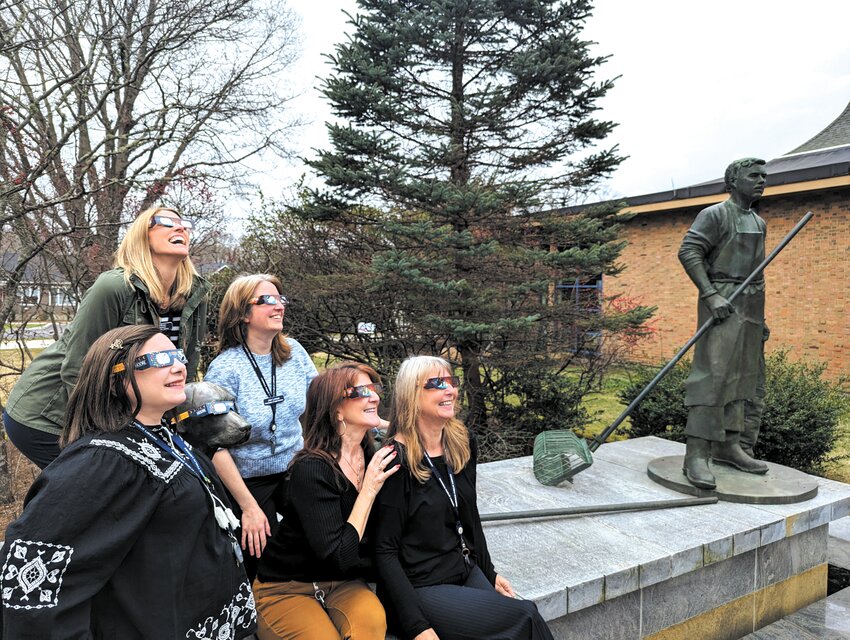 IT WAS A BLACKOUT: Asked to try on their eclipse glasses in preparation for Monday&rsquo;s solar show  library staff from left Andrea Hutnak, Ellen O'Brien, Jen Linton, Kelly DiCenzo and Jules Belanger gathered at the Quahogger statue. &ldquo;It was totally black,&rdquo; O&rsquo;Brien said. Photo courtesy of  Evan Barta.