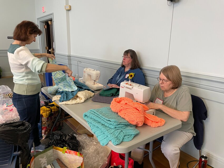 LABELS OF LOVE: The sewing team put 308 labels on blankets that will be distributed to children all across Rhode Island. (Photos by Pam Schiff)