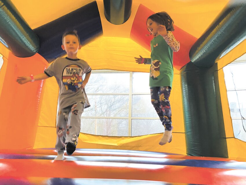 BOUNCING ABOUT:  Ellie Chesser, 7, and Milo Chesser, 5, take a few jumps inside the Kent County YMCA's bounce house. (Christopher Gavin)