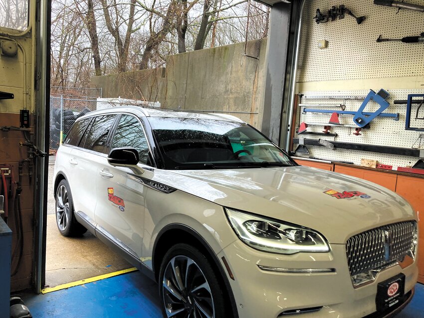 ENTERING ITS NEW HOME: A Tasca employee drives the 2023 Lincoln Aviator into the Warwick Area Career and Technical Center. (Warwick Beacon photo)