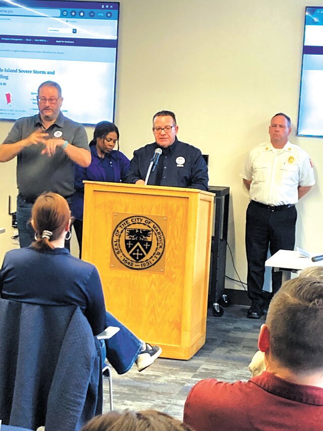 HERE TO HELP: FEMA Federal Coordinating Officer Bob Fogel, flanked by a sign language interpreter, talks to Warwick residents and business owners about how to help receive relief. (Warwick Beacon photo by Adam Zangari)