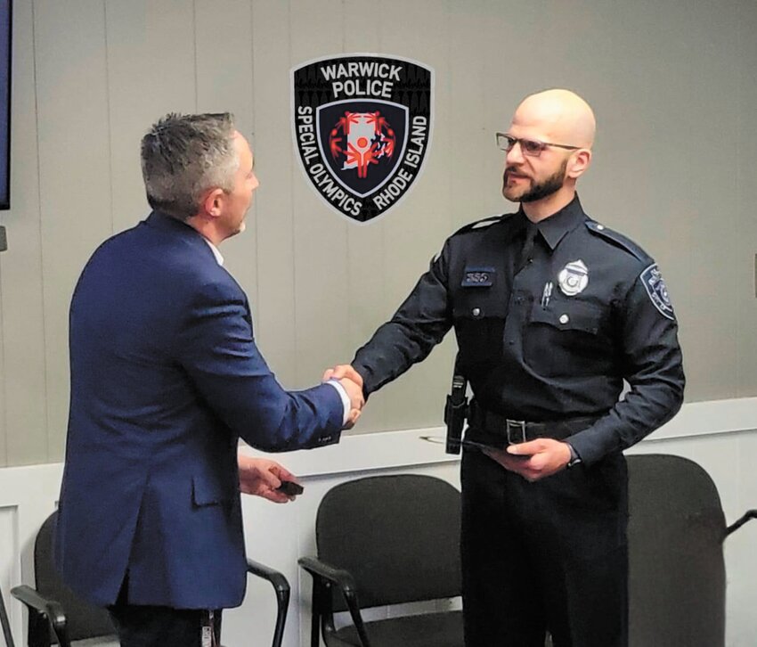 HONORED: Special Olympics RI President and CEO Ed Pacheco (left) met with Warwick police officer Frank Matarese to officially present him with the nomination citation and pin. The winner of the award will be announced on May 3. (Photo courtesy Special Olympics Rhode Island)