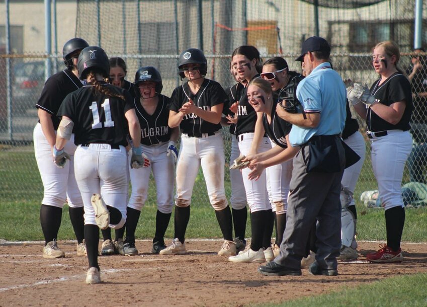 HOME RUN: The Pilgrim softball team meets Skylar Hawes at the plate to celebrate her home run on Monday. (Photos by Alex Sponseller)