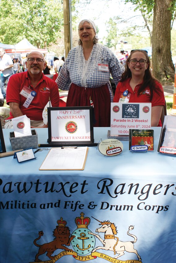 THE RANGERS: From left to right, Larry Perez, executive officer of the Pawtuxet Rangers Fife & Drum Corps, Corp. Trish Woodard (a direct descendent of Capt. Malachi Rhodes, an original member of the Pawtuxet Rangers), and Lt. Rachel Sczurek, supply officer and fife player, manned the Rangers’ booth this weekend. This year, the Pawtuxet Rangers are celebrating their 250th anniversary of their founding as a military unit in 1774.