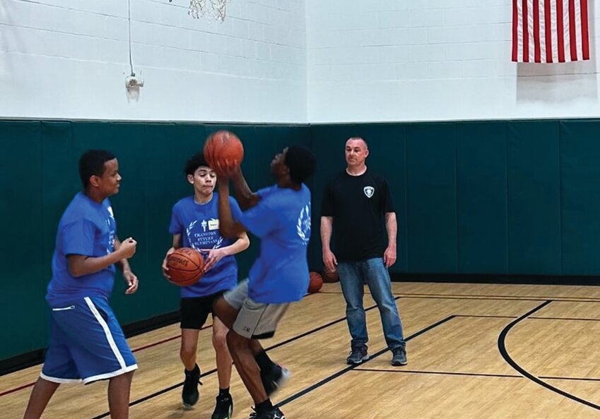 ON THE HARDWOOD: Kids and parents were treated to a couple of free basketball clinics and free pizza when Cranston Police Department partnered with OneCranston Health Equity Zone (HEZ) recently. &ldquo;This is just one of several of these sports clinics we hope to do,&rdquo; according to a Cranston Police post on social media. &ldquo;The mission of HEZ is to support and equip Cranston community members to collaborate and create projects, places, and programming where residents can healthily live, learn, work, and play.&rdquo; (Photos courtesy Cranston Police Department)
