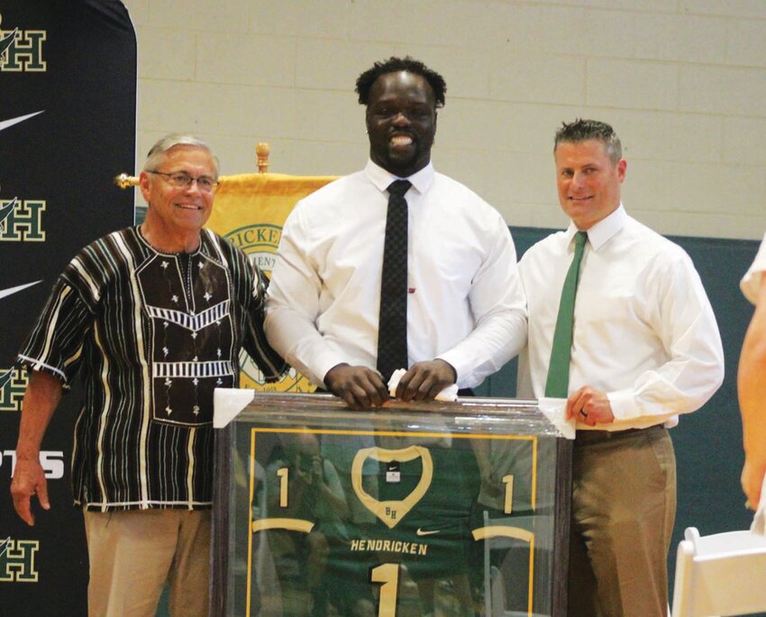 TO THE RAFTERS: Kwity Paye (center) joined by Hendricken coaches Keith Croft and Buddy Croft. (Photo by Alex Sponseller)