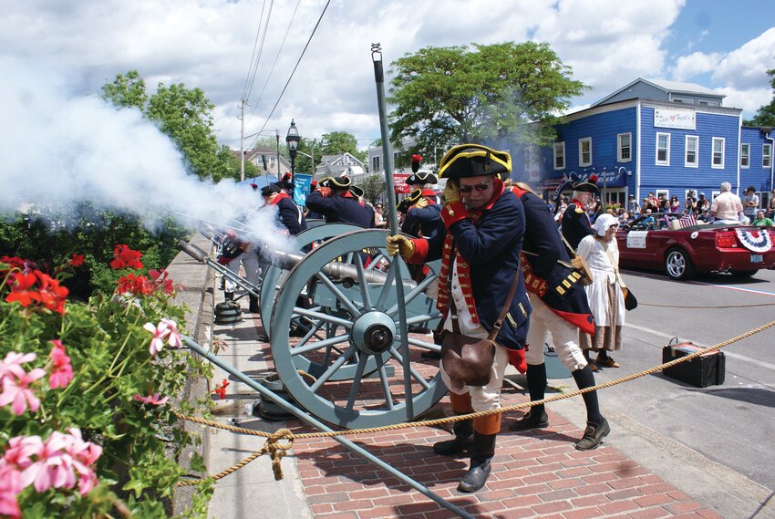 READY, AIM, FIRE: During Saturday’s Gaspee Days Parade, the Artillery Company of Newport 1741 fired cannons from the bridge on the Warwick/Cranston line. For more Gaspee Days coverage, turn to Pages 8-11. (Warwick Beacon photo by Steve Popiel)