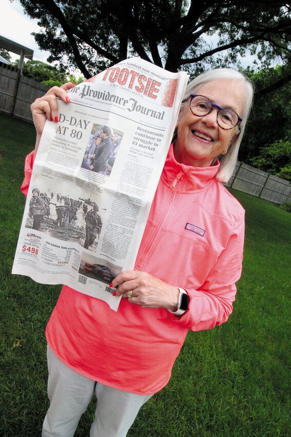 FRONT PAGE NEWS 80 YEARS LATER: Jane McGair, holds  a copy of last Thursday&rsquo;s Providence Journal featuring the photo  of her father  1st Lt. Branson Donaldson as he was in the first wave of allied troops to come ashore on Omaha Beach. (Warwick Beacon photo)