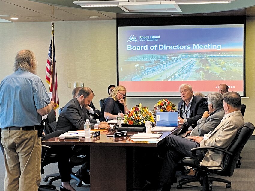 IN RESPONSE TO QUESTIONS: Rhode Island Airport Corporation board Chair Jonathan Savage, third from right, addresses Warwick resident Richard Langseth, left, at last week's meeting. (Warwick Beacon photo)