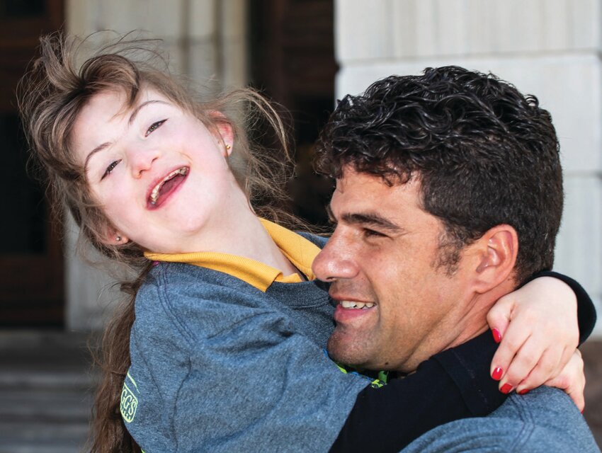 HIS INSPIRATION: Detective Leclerc and his daughter Sofia share a moment at the State House Ceremony for the  2014 Torch Run for Special Olympics Rhode Island.