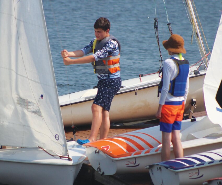 READY FOR THE SUMMER: Youth instructor Graham Spurrell organizes the sailors as they go through the youth program.
