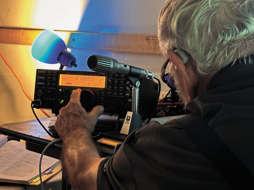 RETUNING RADIO: Vic Farmer adjusts a radio knob to make a clearer connection with other stations around the country. (Warwick Beacon photos)