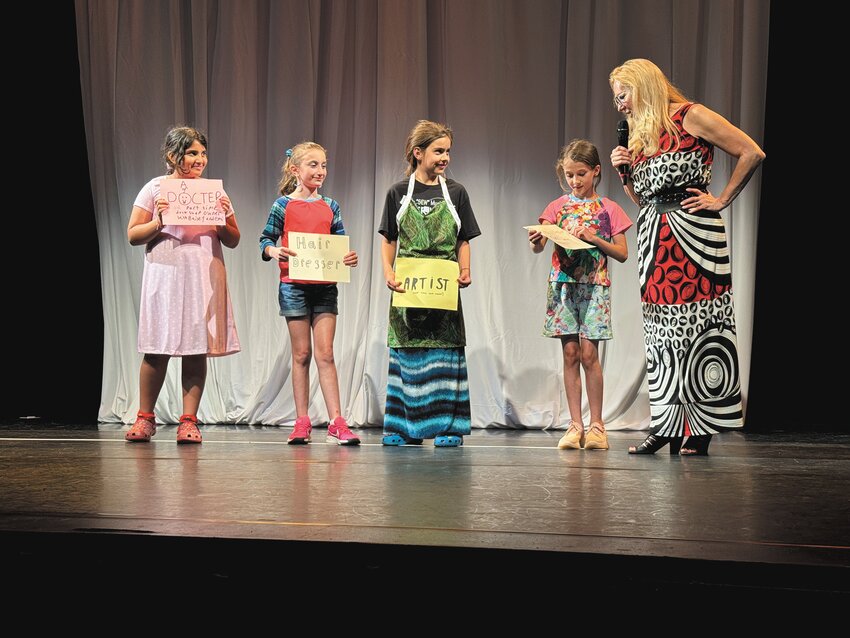 WHAT THEY WANT TO BE: Lydia Simones (far left), Giulia DiIorio (center left), Emi Bernabe (center), and Bailey Miller (far right) are center stage describing what they want to be when they grow up.