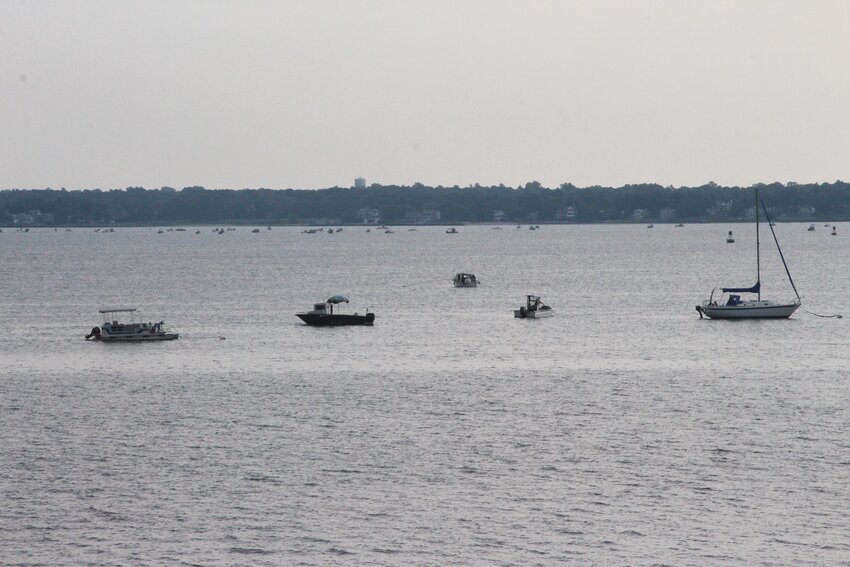 CLOSE TO SHORE: Quahoggers work the Providence River north of Conimicut Light that until four years ago had been closed to shellfishing for more than 70 years. (Warwick Beacon photo)
