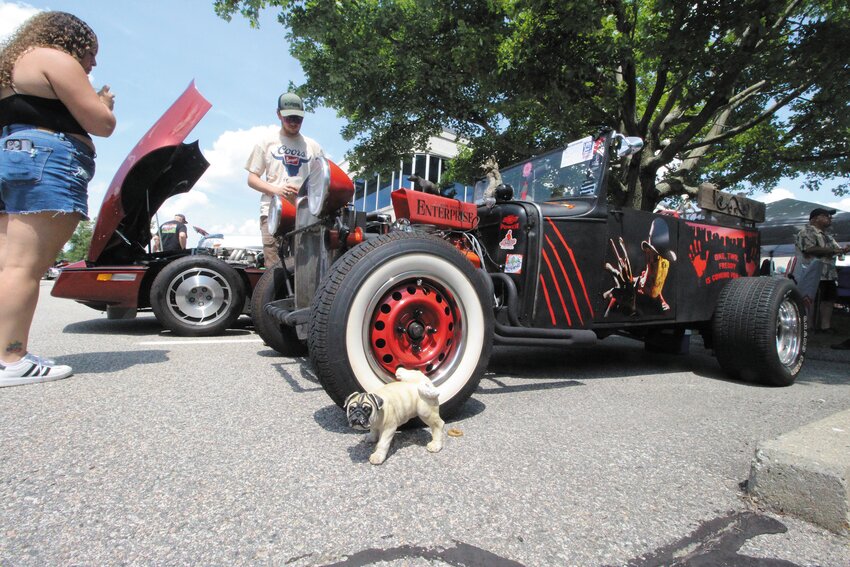 WHAT DOGS DO:  The art work and figurines including a bulldog christening a tire on this car provided entertainment for spectators.