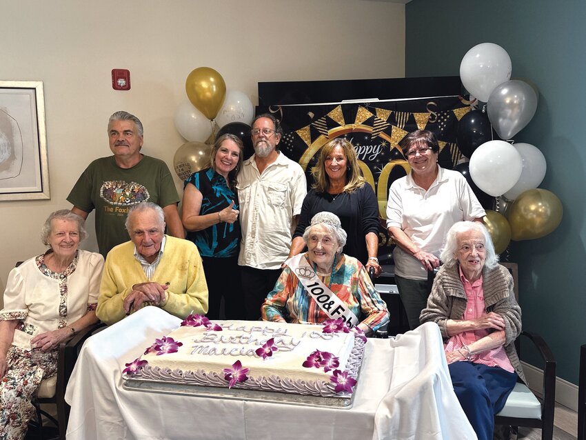 FAMILY CELEBRATION: Marcia Sprague (center) celebrates her 100th birthday surrounded by family at the Briarcliffe Retirement &amp; Assisted Living facility. (Johnston SunRise photos by Ryan Doherty)