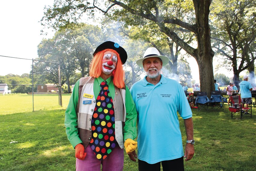 CLOWNING AROUND: Mark Eaton, chairman of the RI Elks Major State Project, smiles for a photo with Disco, one of the Shriners Clowns.