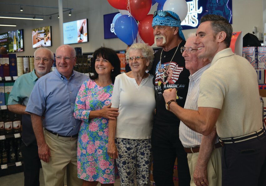 HULK THE HAWKER: WWE Hall of Fame wrestler and American legend Hulk Hogan made numerous Ocean State appearances early last week. He stopped by Christy’s Liquors at 1350 Oaklawn Ave. in Cranston Wednesday, posing for photos with customers who bought his beer. (Cranston Herald photos by Rory Schuler)